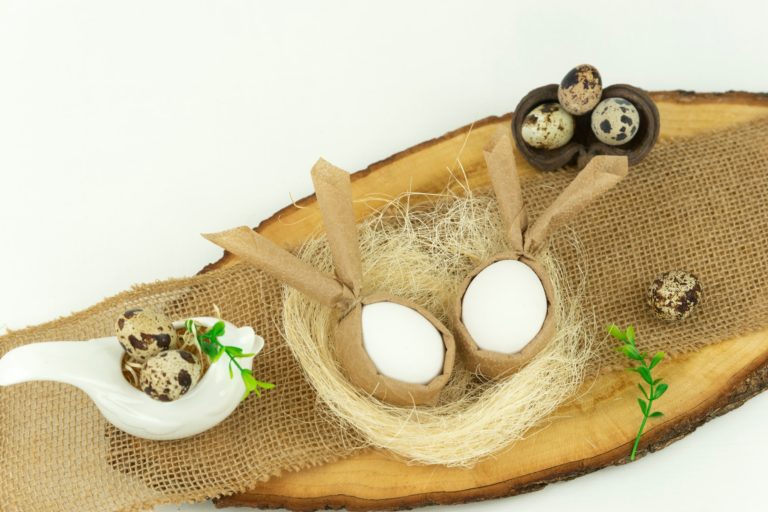 Funny Easter eggs lying in a straw nest as a decoration for happy hollidays. Eco friendly Easter